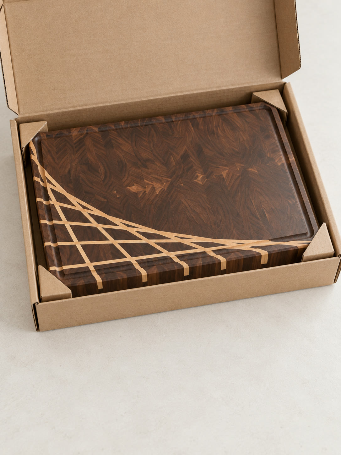 A juice groove board with the maple ray packed in a shipping box